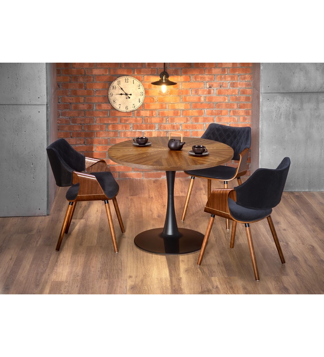 Designerski stół CARMELO 100 cm w kolorze orzecha świetnie zaprezentuje się w salonie, pokoju, kuchni czy jadalni.
