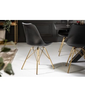 Świetne krzesło z metalowymi nogami w kolorze złotym oraz siedziskiem w kolorze czarnym do salonu oraz jadalni.